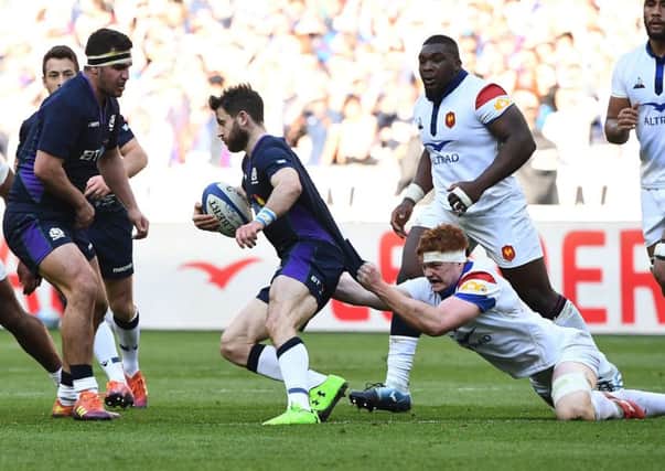 Scotland winger Tommy Seymour is tackled by France lock Felix Lambey