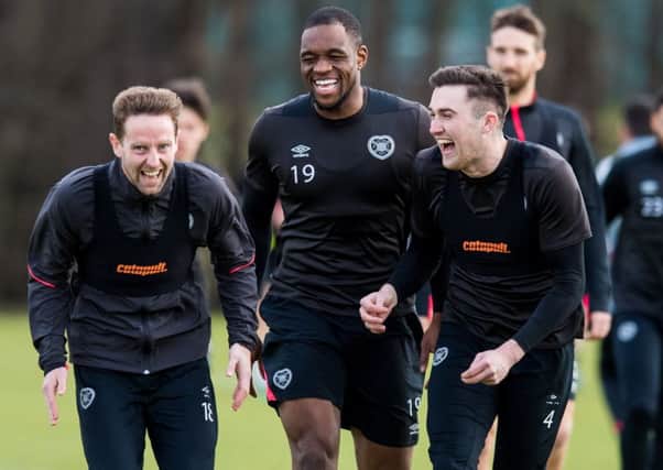John Souttar, right, enjoys a laugh in training with Steven MacLean and Uche Ikpeazu