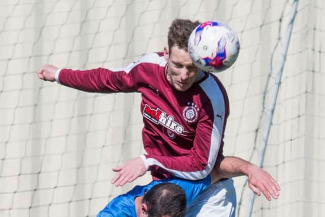 Jamie McKenzie wins a header against Musselburgh Athletic's Mathu King