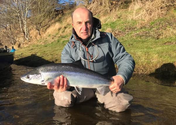 Mike Graham with the fish which won him the Tweed Trophy for the first salmon caught on the river this year