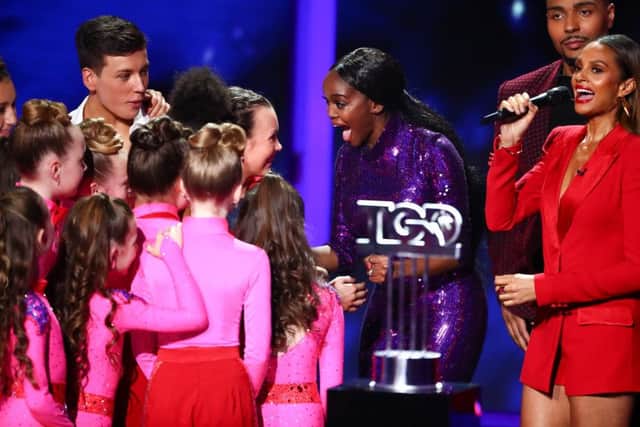 Ellie Fergusson celebrates with mentor Oti Mabuse as the result is announced by host Alesh Dixon. Picture: Tom Dymond