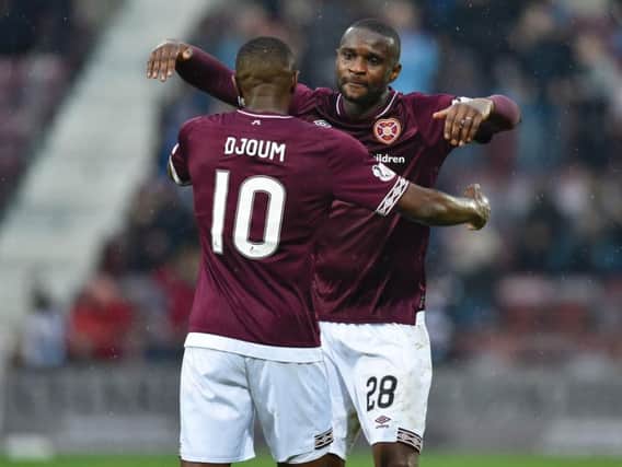 Clevid Dikamona and Arnaud Djoum embrace after the former's goal.