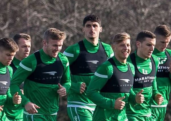 Kosovar Sadiki, centre, is put through his paces with the Hibs squad at East Mains. Picture: SNS Group