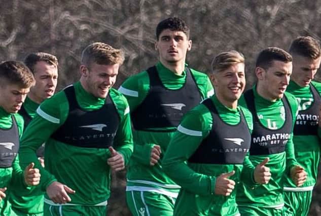 Kosovar Sadiki, centre, is put through his paces with the Hibs squad at East Mains. Picture: SNS Group