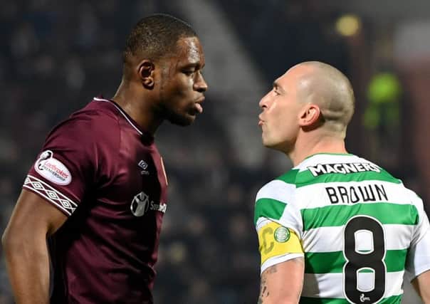 Uche Ikpeazu, left, seen here staring down Celtic captain Scott Brown, was back to his best against the Hoops. Picture: SNS Group