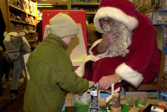 Photo: Andrew Stuart/NW. Aiden Thompson agaed 3, plays in Jenners' toy department with Santa Claus, Edinburgh; December 2, 2001.