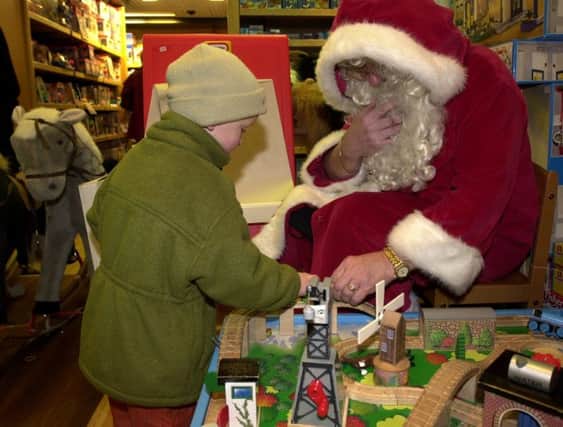 Photo: Andrew Stuart/NW. Aiden Thompson agaed 3, plays in Jenners' toy department with Santa Claus, Edinburgh; December 2, 2001.