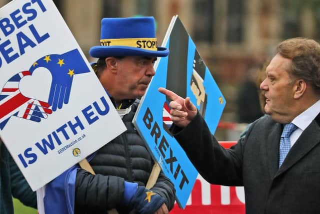 Protesters argue outside the Houses of Parliament as the date for exiting the EU looms ever closer. Picture: AP