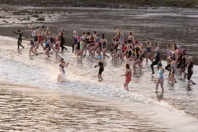 The event began with a safety briefing. At this time of year it is dangerous to stay in for too long. After a quick three minute dip the swimmers came out and warmed up by the bonfire with tea and cake.