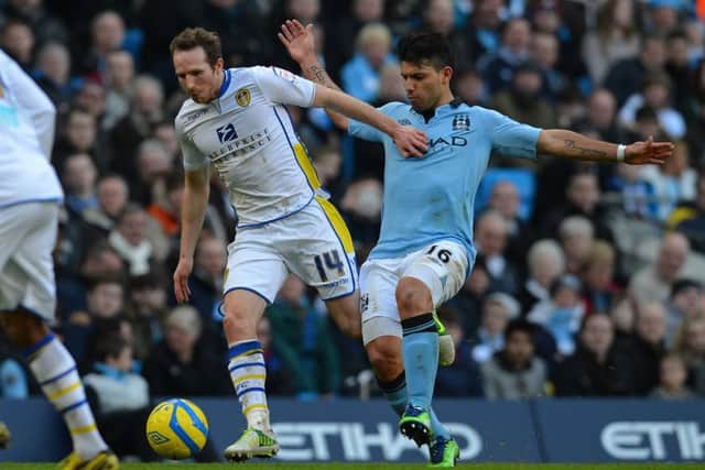 Aidy White battles against Sergio Aguero during an FA Cup match between Leeds United and Manchester City at the Etihad. Picture: AFP/Getty