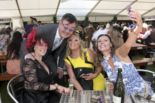 Horse Racing, Musselburgh Ladies Day. Grant Stott gets in on the action with left to right Lisa Wann, Lee Archibald and Julie Mitchell.