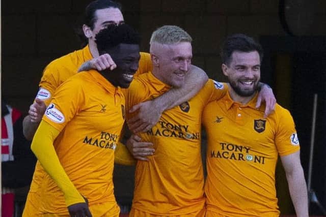 Livingston celebrate after Craig Sibbald, centre, made it 2-1