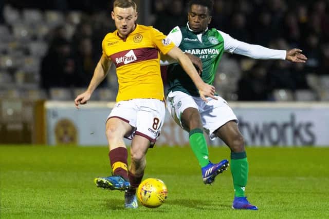 Omeonga competes with Motherwell's Allan Campbell during a tough baptism at Fir Park