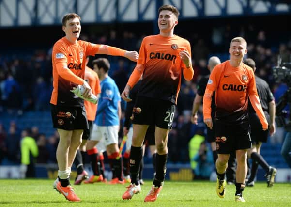John Souttar, centre, celebrates a Scottish Cup win at Ibox in 2014 alongside Andy Robertson, left, and Ryan Gauld. Pic: SNS