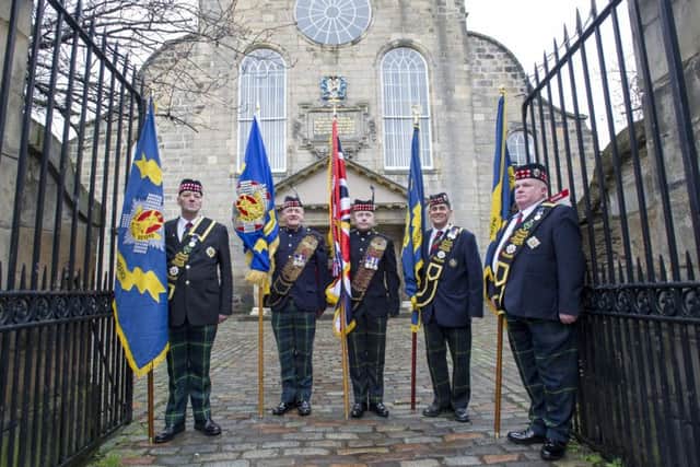 Royal Scots standard bearers outside before the Royal Scots Club commemorative church service at Canongate Kirk, Edinburgh.