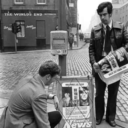 Detectives putting up Evening News posters in the High Street for information about the The World's End Murders (Christine Eadie and Helen Scott) in Edinburgh, October 1977.