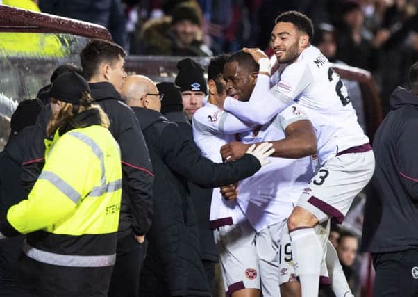 Hearts' 
Uche Ikpeazu (centre) celebrates with the dugout after equalising against Partick. Pic: SNS