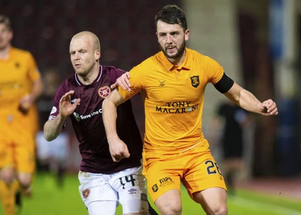 Craig Halkett in action for Livingston against Hearts' Steven Naismith. Picture: SNS Group