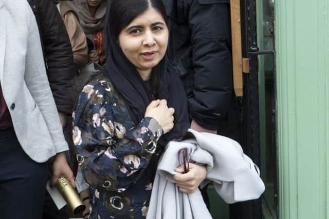 Malala Yousafzai, activist for female education and the youngest Nobel Prize laureate, leaves Vesta Restaurant & Bar in Edinburgh surrounded by security.