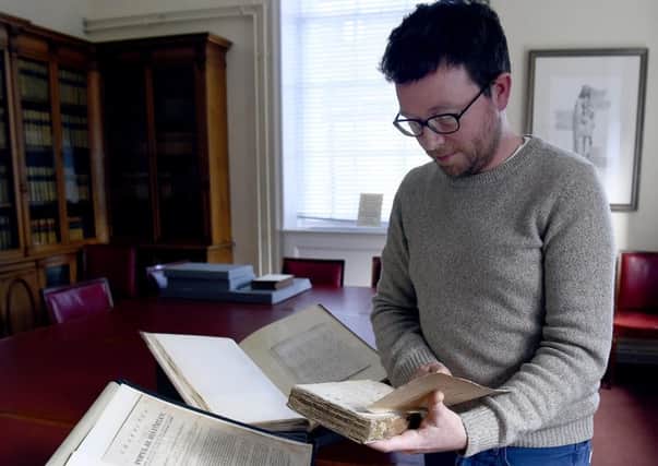 Curator Robert Betteridge holds Poems Chiefly In The Scottish Dialect by Robert Burns. Picture: Lisa Ferguson