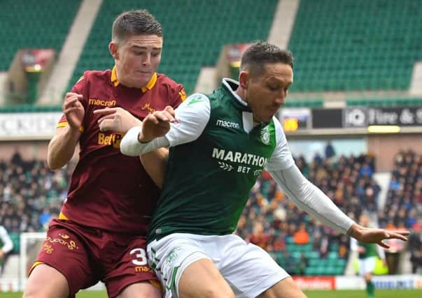 Mark Milligan holds off Motherwell's Jake Hastie during a fine display at centre-back