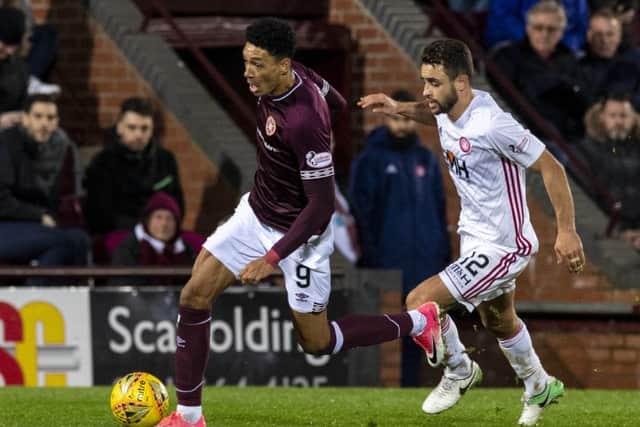 Sean Clare skips away from Tom Taiwo during the last meeting between Hearts and Hamilton. Picture: SNS Group