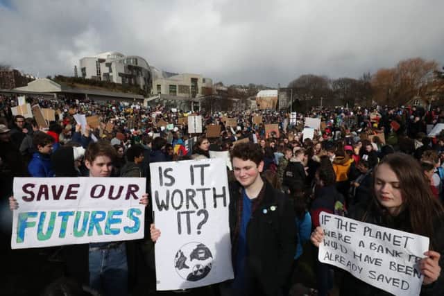 Students take part in a global school strike for climate change outside the Scottish Parliament building in Edinburgh, as protests are planned in 100 towns and cities in the UK. Pic: Jane Barlow/PA Wire