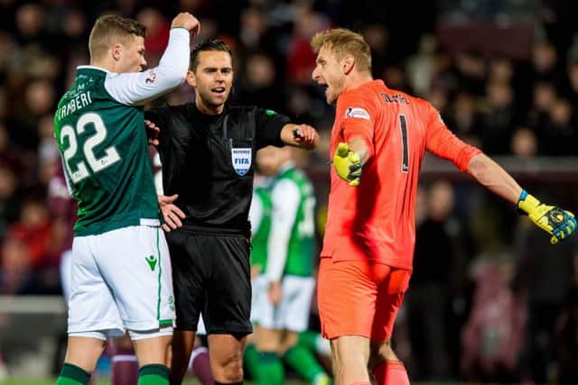 Hibernian's Florian Kamberi and Hearts' Zdenek Zlamal exchange words as referee Andrew Dallas intervines. Picture: SNS/Ross Parker