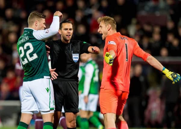 Hibernian's Florian Kamberi and Hearts' Zdenek Zlamal exchange words as referee Andrew Dallas intervines. Picture: SNS/Ross Parker