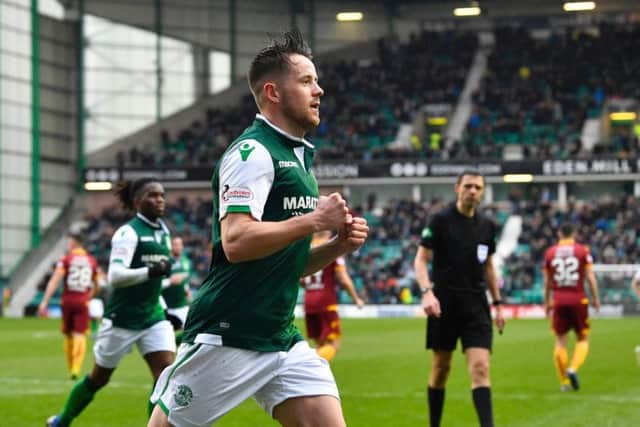 Marc McNulty turns away in celebration after opening the scoring for Hibs against Motherwell