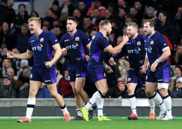 Finn Russell celebrates scoring the fifth try for Scotland. Picture: PA