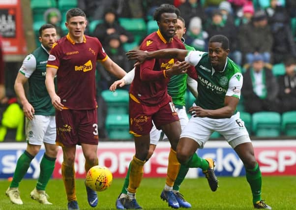 Hibs' Marvin Bartley competes with Gboly Ariyibi during the 2-0 win over Motherwell. Pic: SNS