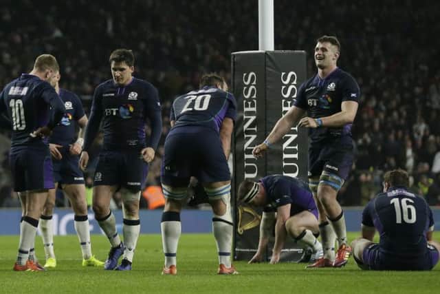 The Scotland players react after England's George Ford scored a try with almost the last play. He then converted it to make it 38-38