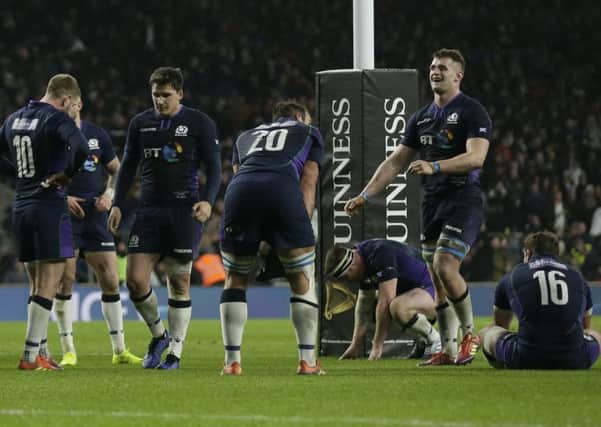 The Scotland players react after England's George Ford scored a try with almost the last play. He then converted it to make it 38-38