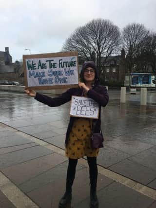 Harriet Sweatman protests against climate change outside the Scottish Parliament