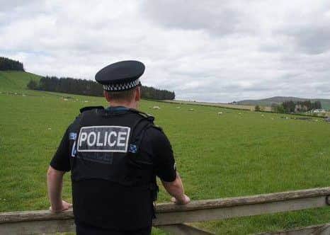 A police officer looks onto a field. Pic: Police Scotland