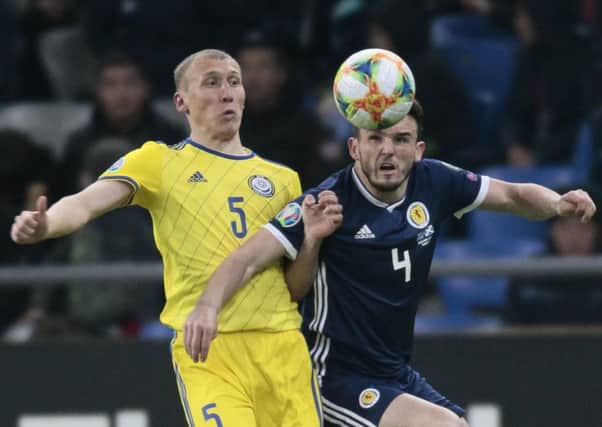 John McGinn wins the ball in midfield against Kazakhstan. He says players are to blame for the loss, not Alex McLeish. Picture: AP Photo/Alexei Filippov