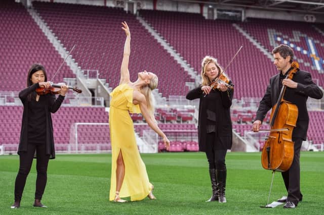 Ballet dancer Eve Mutso and Donald Gillan (Cello), Kana Kawashima, Amira Bedrush-McDonald (violin) from the Scottish Chamber Orchestra celebrate the launch of the 2019 Edinburgh International Festival programme at Tynecastle Park. Picture: Andrew O'Brien