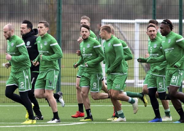 Hibs skipper David Gray, left, leads his team during a warm-up session at East Mains in preparation for Fridays game