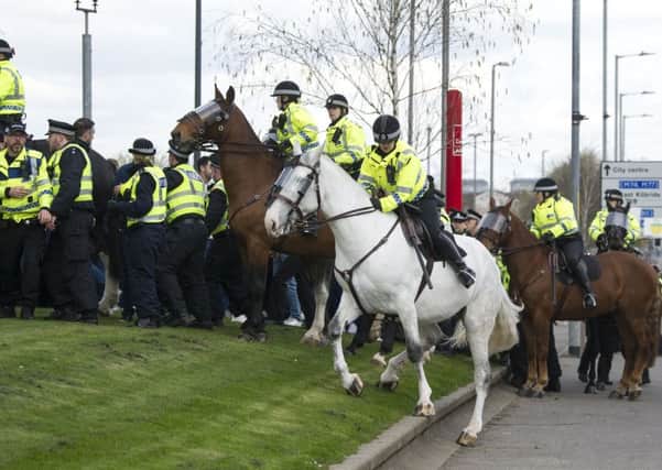 Police endeavour to restrain Old Firm fans ahead of the Celtic-Rangers match last weekend (Picture: John Devlin)