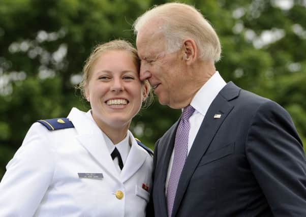 Newly commissioned officer Erin Talbot poses for a photograph with the then Vice President Joe Biden at the US Coast Guard Academy in 2013 (Picture: Jessica Hill/AP)