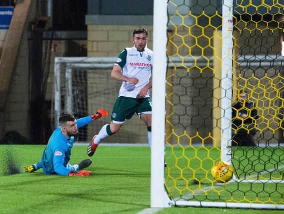 Stevie Mallan wraps up the points for Hibs as he passed the ball beyond Liam Kelly.