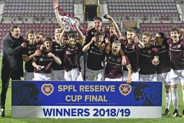 Coach Andy Kirk, far left, celebrates with the Cup and his players. Picture: Neil Hanna