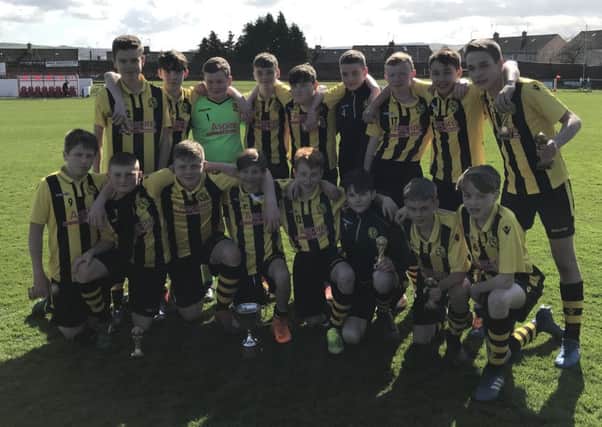Hutchison Vale Colts Under-14s show off the David Innes Cup after beating Redhall Star