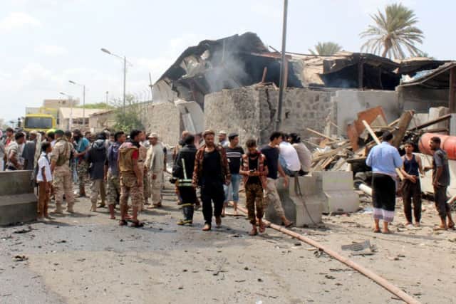 Yemenis gather near the scene of an explosion resulting from a suicide bombing, claimed by the Islamic State (IS) group which hit UAE-trained Yemeni troops on March 13, 2018 in the southern Yemeni city of Aden. Pic: Saleh Al-Obeidi/
AFP/Getty Images)