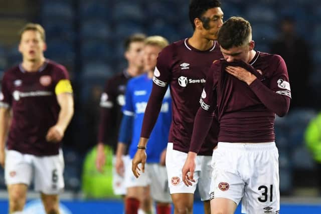 A dejected Bobby Burns leaves the pitch after Hearts were beaten 3-0 by Rangers on a difficult night for the Capital side at Ibrox