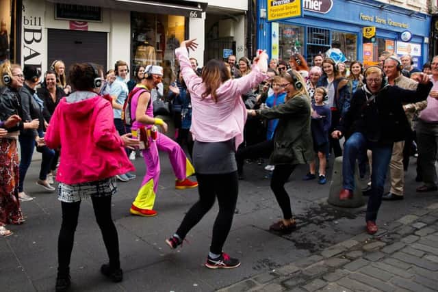 Silent Disco Walking Tour sensation Guru Dudu leads his guests through the Grassmarket during the Fringe