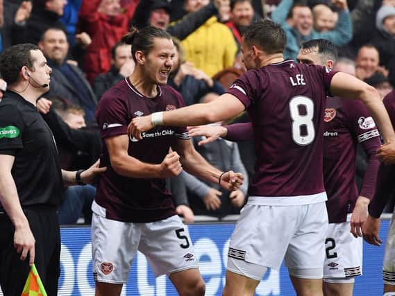 Peter Haring celebrates with Olly Lee after giving Hearts the lead.