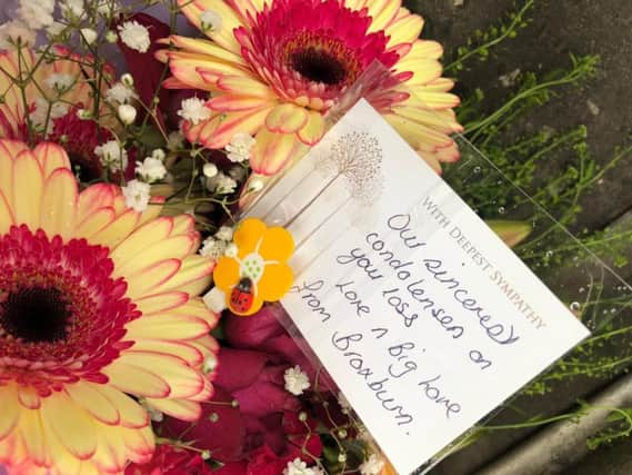 Tributes have been laid at the site of the incident in Broxburn.