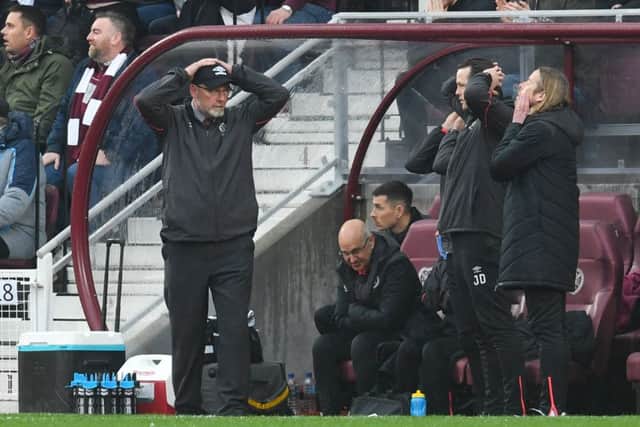 Craig Levein and his coaching staff react after a missed chance during Hearts' defeat to Hibs. Picture: SNS